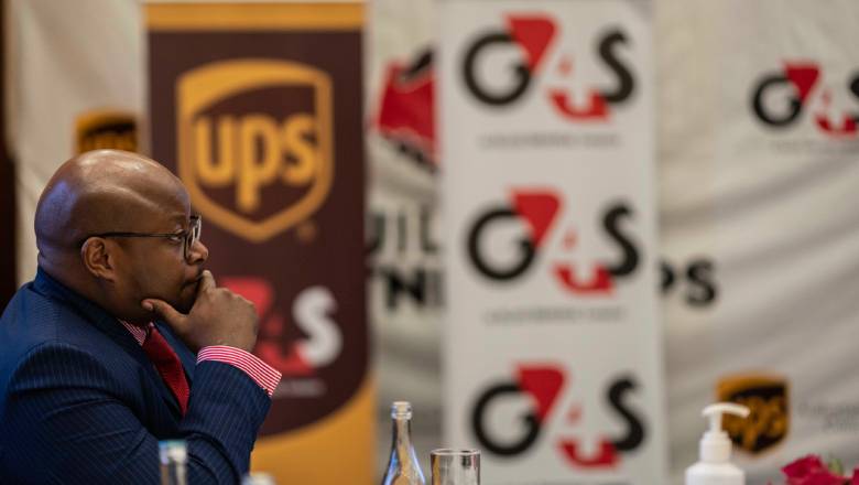 G4S Kenya Director of Secure Logistics, Hilary Itela, listening. In the background are G4S and UPS branded banners