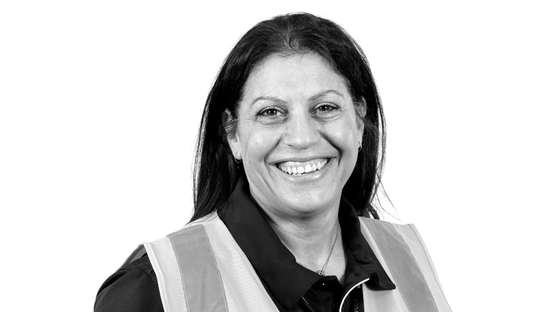 Female G4S staff member wearing high-vis vest on white background