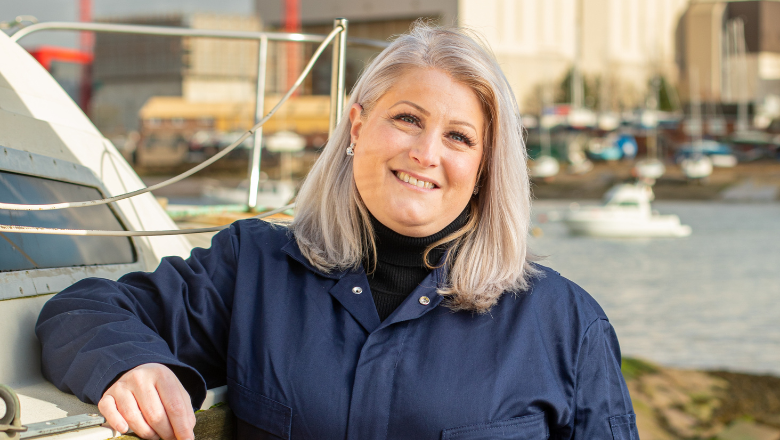 A smiley lady standing in front of a dock